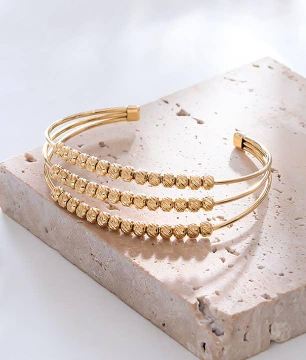 Brazalete (pulsera) dorado con forma de bola y brazalete de triple línea - contigosoy